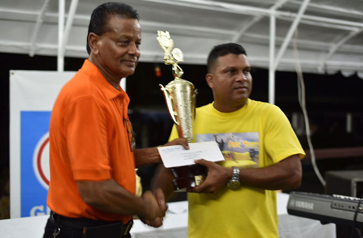 Dave Scott collects his trophy from Lake Mainstay Director Wilfred Jagnarine.