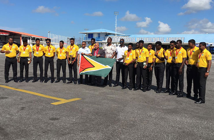 Incumbent Minister of Sport Dr George Norton stands with the victorious U-19 team, Director of Sport Christopher Jones  and GCB executives.