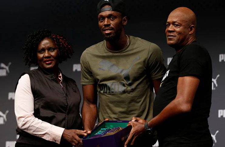 Usain Bolt’s parents presented him with his last race shoes. (Source: Reuters)