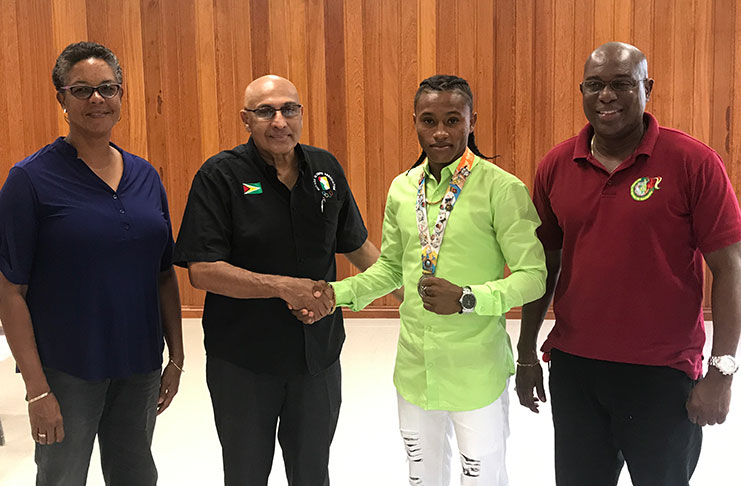 SUPPORT! GOA president KA Juman-Yassin and Keevin Allicock sealed the deal of financial support from the Guyana  Olympic Association with a symbolic hand-shake. Also in photo, GBA president Steve Ninvalle (first from right) and Dr. Karen Pilgrim.