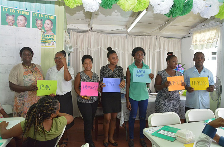 Some of the participants in the workshop display placards bearing the ‘Six Ps’ of Business, during the interactive session (MOPT photo)