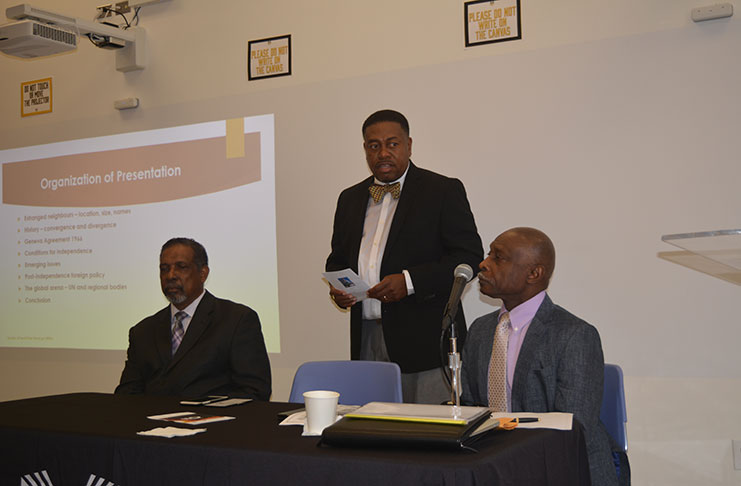 Dean Terrence Blackman addressing Monday’s ‘Promise of Oil’ forum at MEC. Seated left and right respectively are Professor Eugene Pursoo, the former Grenadian Ambassador to the United Nations, and Guyana’s Foreign Minister, Mr  Carl Greenidge