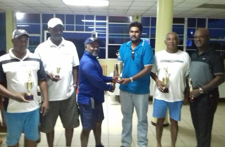 STP Investments’ Managing Director Sanjay Persaud (third from right) hands trophy to winner Balgobin Ragnauth, while the other prize winners share the moment.