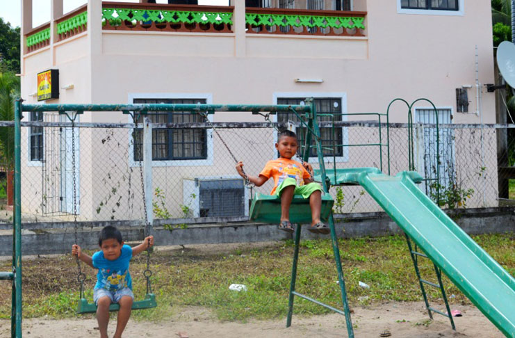 Two children at the play park near the Micobie Primary School in Region Eight
