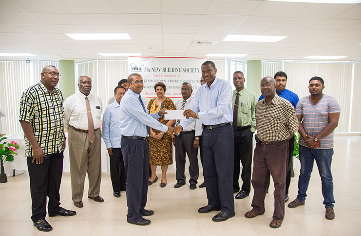 NBS’s CEO Anil Kishun presents the sponsorship cheque to GCA president Roger Harper. Also sharing the moment are NBS Chairman Floyd McDonald (second left) and few NBS Board of Directors, staff and GCA‘s executive members. (Samuel Maughn photo)