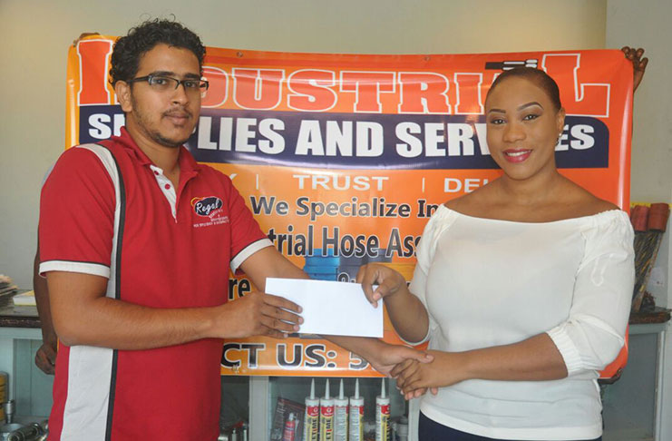 Manager of Industrial Supplies and Services, Thelisha Case, hands over the sponsorship cheque to Treasurer of the GSCL Inc., Russel Jadbeer.