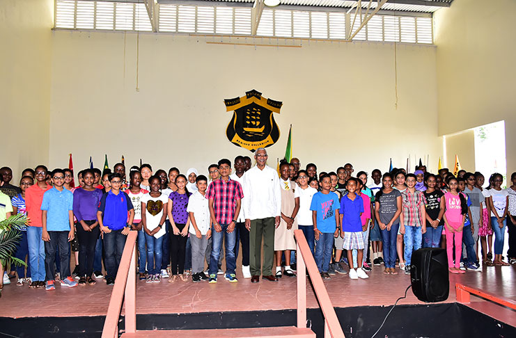 President David Granger with this year's batch of first-form students in the Queen's College Auditorium on Friday