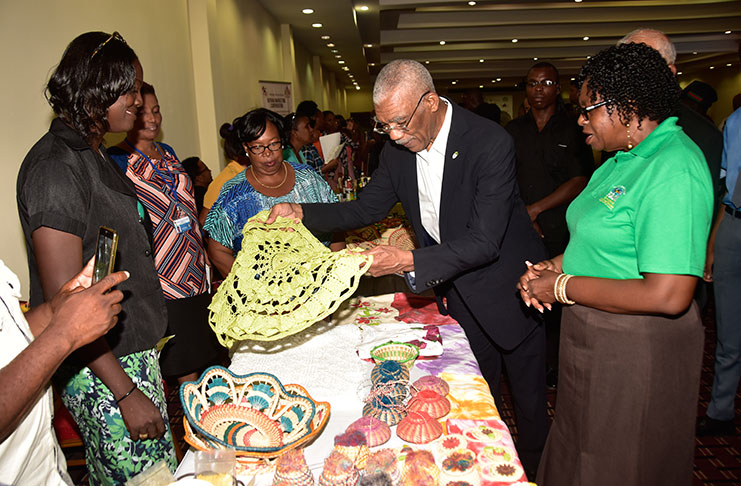President David Granger viewing some of the art and craft exhibits during the launch
