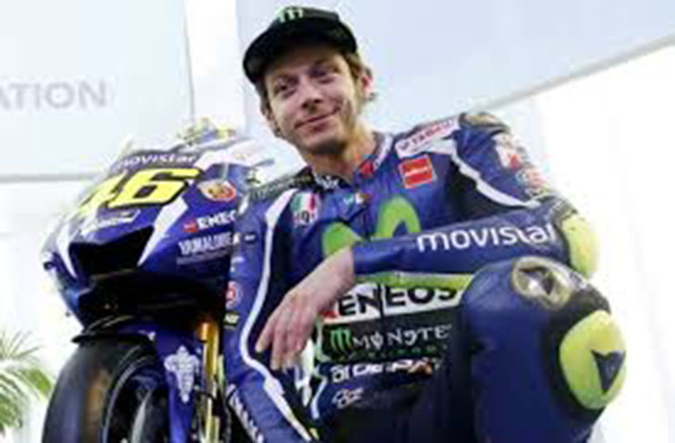 Yamaha's MotoGP rider Valentino Rossi poses with the new Yamaha YZR-M1 for the 2016 season in Barcelona, Spain, January 18, 2016. (REUTERS/Albert Gea)