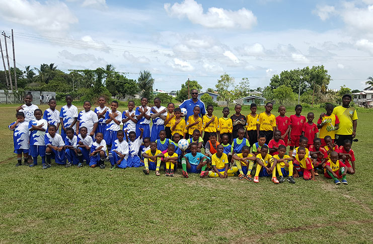 GFF president Wayne Forde and Coaches Association president Wayne Dover with the participating U-11 teams who played on Saturday.