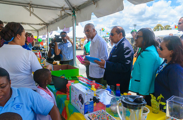 President David Granger, Prime Minister, Moses Nagamootoo, Junior Minister of Public Health, Dr Karen Cummings and Minister
of Public Affairs, Dawn Hasting-Williams inspecting some of the tablets on display at one of the booths at Durban Park
during the Education Day rally on Friday. Also in photo is Minister of Education, Nicolette Henry (Delano Williams photo)