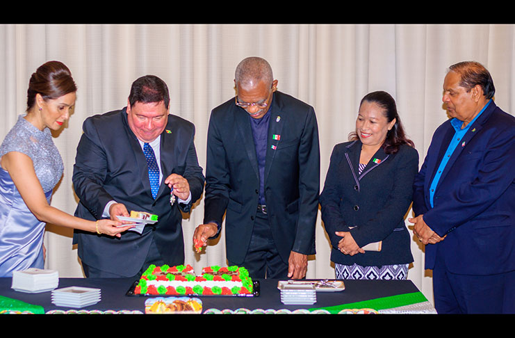 President David Granger and Mexican Ambassador Ivan Roberto Sierra-Medel cut the cake as Prime Minister Moses Nagamootoo and others look on