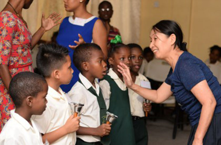 Japan International Co-operation Agency (JICA) instructor, Yuko Aoki singing along with the St. Sidwell Primary School students