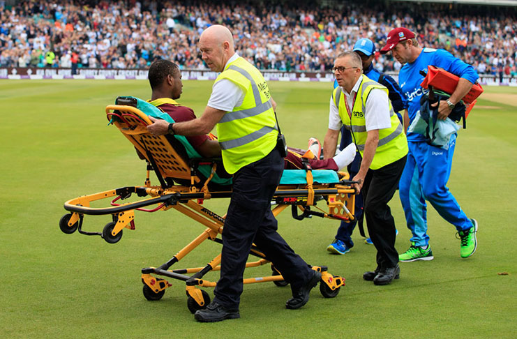 Evin Lewis had to be taken off on a stretcher and was later diagnosed with a hairline fracture. (AFP)
