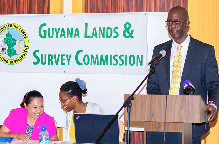 Commissioner of the Guyana Lands and Survey, Trevor Benn, addresses participants at the workshop. Also in photo at head table, is Minister of Public Affairs, Dawn Hasting-Williams