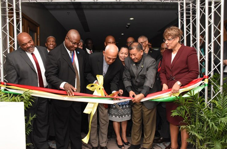Minister of Communities, Ronald Bulkan cutting the ribbon on Monday to declare open the CWWA meeting at the Marriott Hotel. Helping him do the honours are Minister of Indigenous Peoples Affairs, Mr Sydney Allicock (second right) and CWWA President, Mr Alphonsus Daniel (second left)