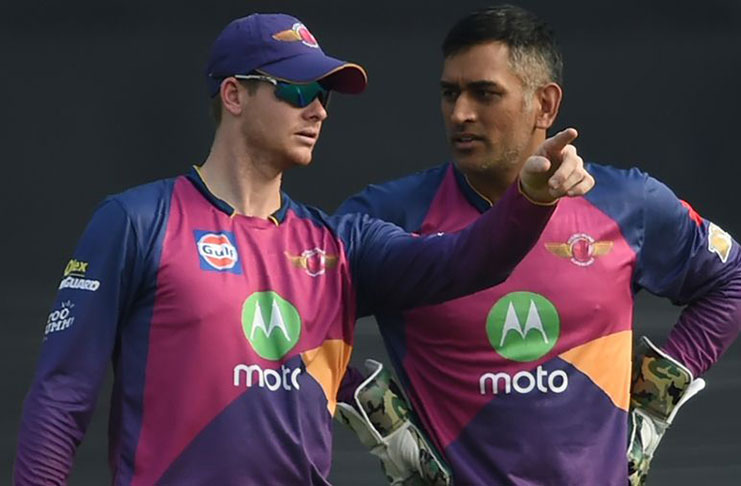 Steven Smith and MS Dhoni have a chat in the field AFP
