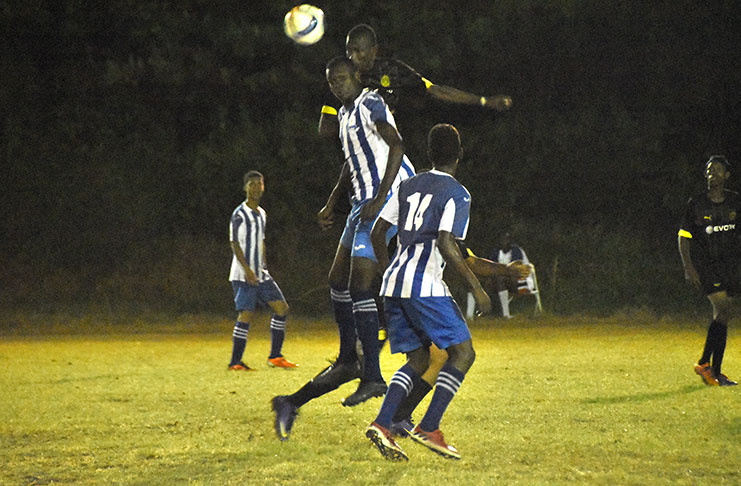 A Silver Shattas player is flanked by two GFC Players as he tries to head the ball in Tuesday evening’s Turbo Knock Out football at the Ministry of Education ground (Adrian Narine Photo)