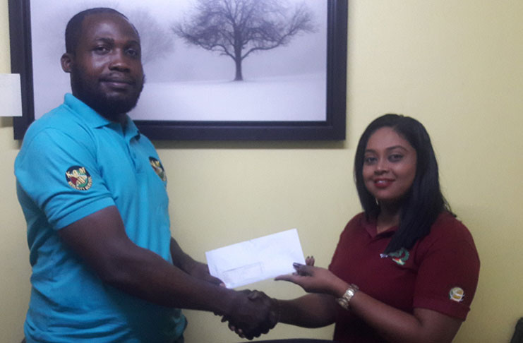 KGM’s Andre Peters hands over the cheque to GMR&SC’s Tina Morris.