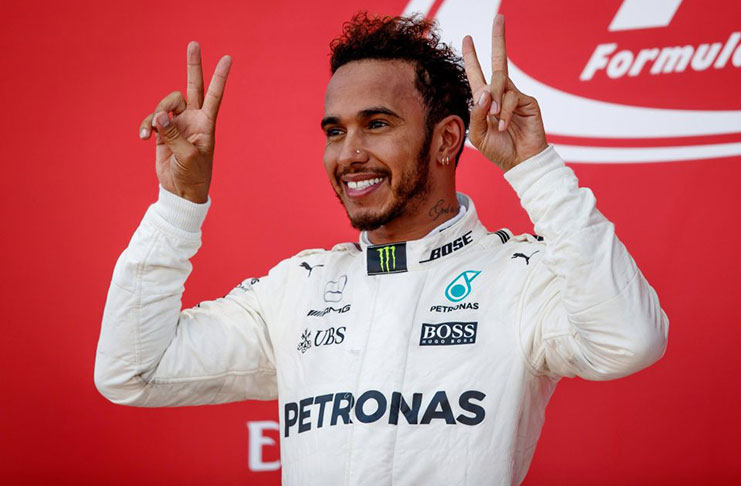 Lewis Hamilton gives a V for victory at the Japanese Grand Prix