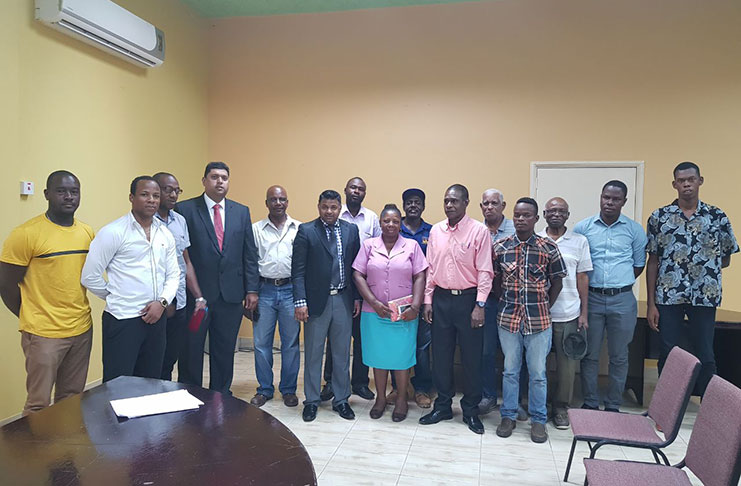 Indar and Ramnarine (fourth and sixth left respectively) with some of the Linden businessmen who attended the meeting