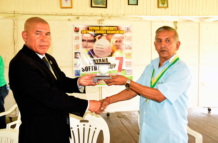 President of the GFSCA, Ramchand Ragbeer, makes a presentation to Minister of Social Cohesion, with responsibility for Culture, Youth and Sport Dr George Norton.