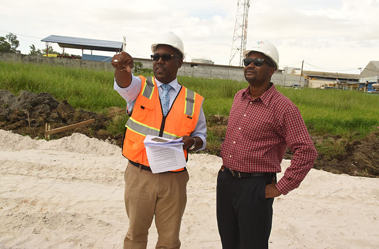 GFF’s VP, Rawlston Adams, (left) and president, Wayne Forde, examining the work on the country’s first home for football. (Adrian Narine photos)