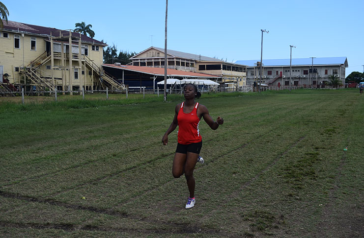 Chase Academic Foundation’s Kenisha Phillips takes a huge win in the Girls’ Under-18 400m yesterday. Her competitors can faintly be seen in the distance.