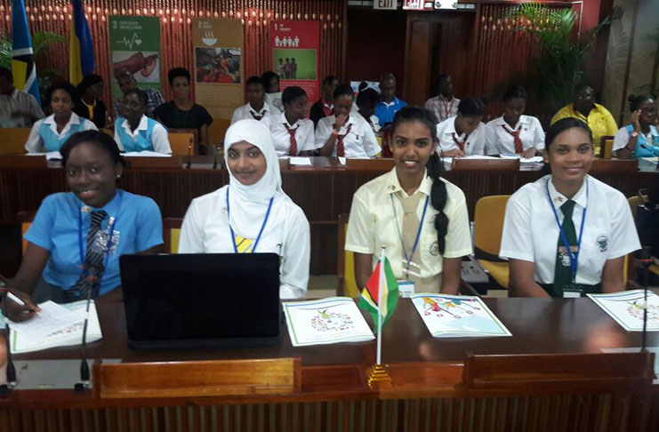 The four Guyanese students at the Jamaica Conference Centre where the two-day climate conference is being held