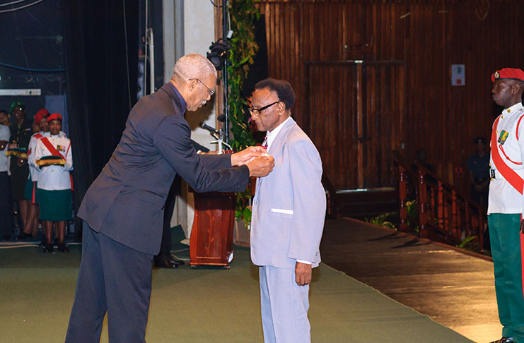 President David Granger decorates, Veteran Journalist of the Guyana Chronicle George Barclay with his Medal of Service at Friday’s Investiture Ceremony held at the National Cultural Centre (Delano Williams photo)