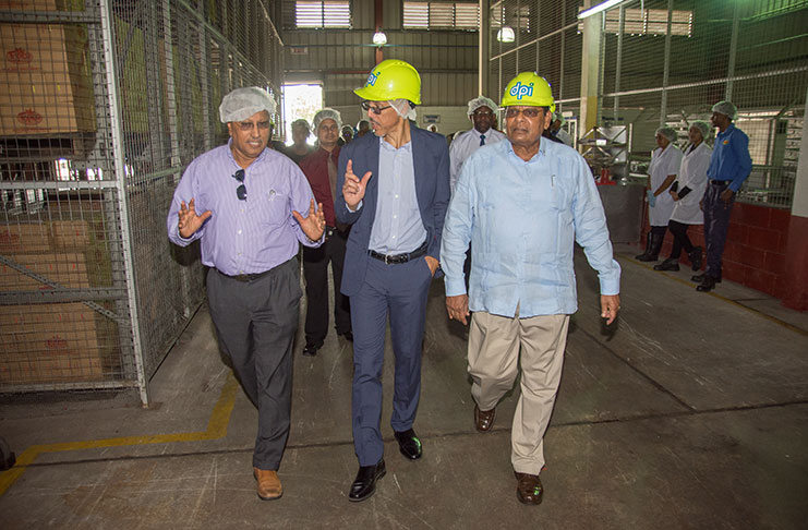 Prime Minister, Moses Nagamootoo (right) and Minister of Business, Dominic Gaskin being briefed by Chairman of the Demerara Distillers Limited, Komal Samaroo during a tour of the company’s Diamond, East Bank Demerara facility on Wednesday (Samuel Maughn photo)