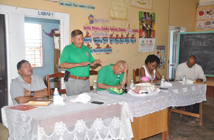 Minister of Indigenous Peoples Affairs, Sydney Allicock (standing), makes a point Saturday to residents of Hiawa, Rupununi, Region Nine. Also seated at head-table are left to right, Regional Chairman, Brian Allicock; Minister of Social Cohesion, Dr George Norton; Sharon Patterson, Programme Coordinator and Shabbir Ali, Technical Officer, Ministry of Social Cohesion (Delano Williams)
