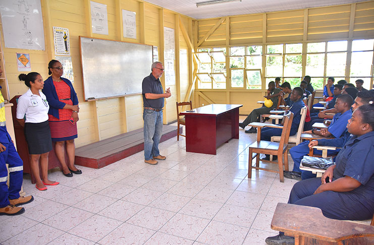Gen-Equip Managing-Director, Renger Van Dijk (centre) speaking to students and GTI Principal Ms Renita Crandon-Duncan (second left) about the new aspect of the school’s agricultural programme