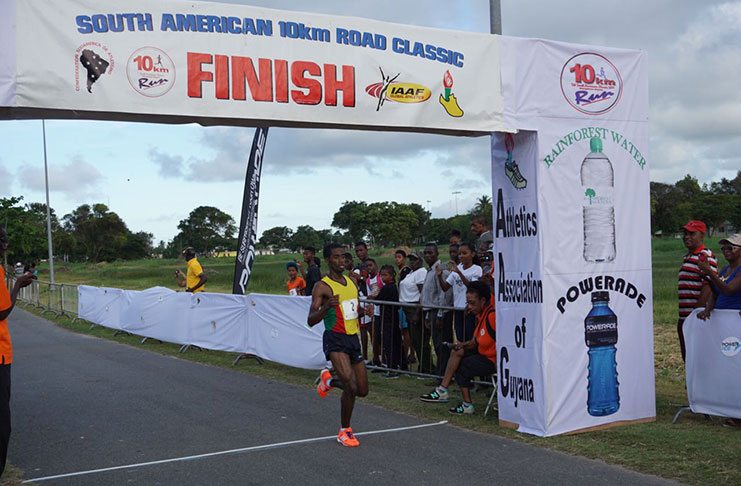 Guyana’s Cleveland Forde crossing the finish line unchallenged at yesterday’s South American 10km.