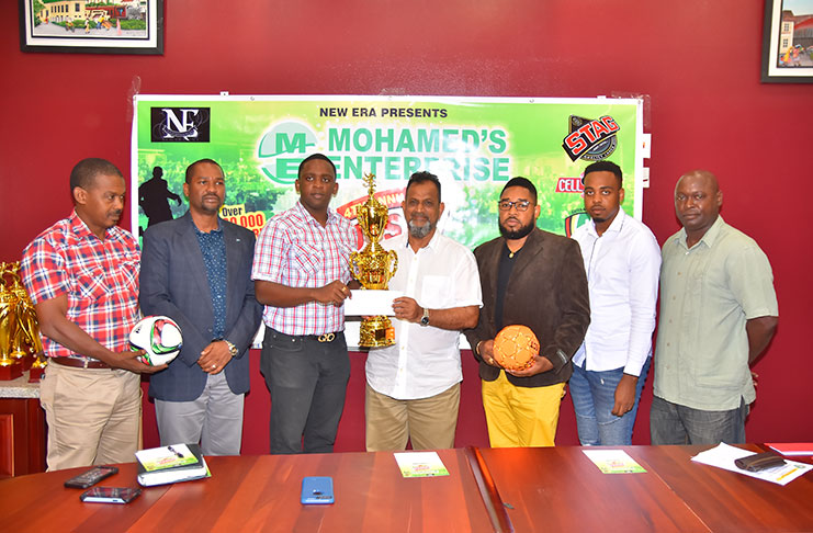 New Era Entertainment’s Andrew Major receives the first place trophy and prize from Nazar Mohamed (Samuel Maughn photo)