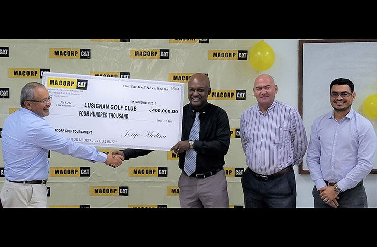 Jorge Medina (left) hands over cheque to Brian Hackett in the presence of other MACORP and Lusignan Golf Club officials.