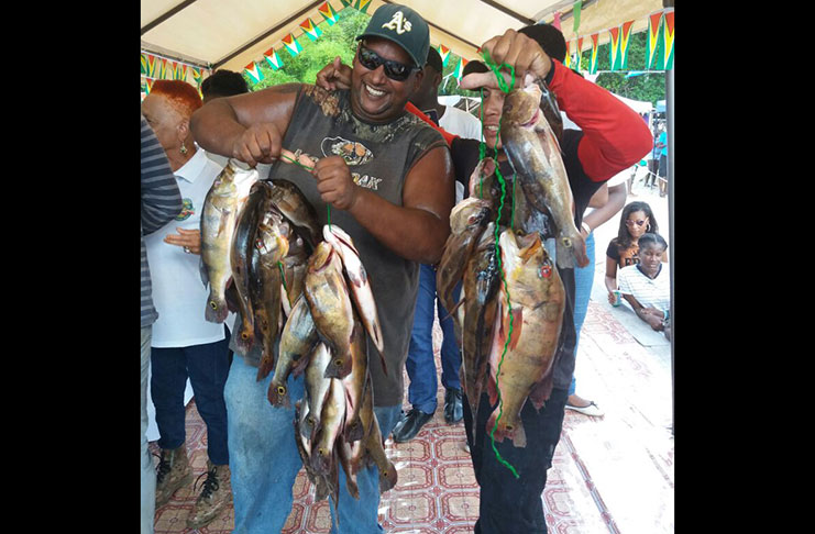 Ravi Persaud (left) of Amelia’s Ward, who had the largest single catch of the day. With him, at right, is boat captain, Ray Peters from Rockstone, who took him to the Essequibo River to make the catch