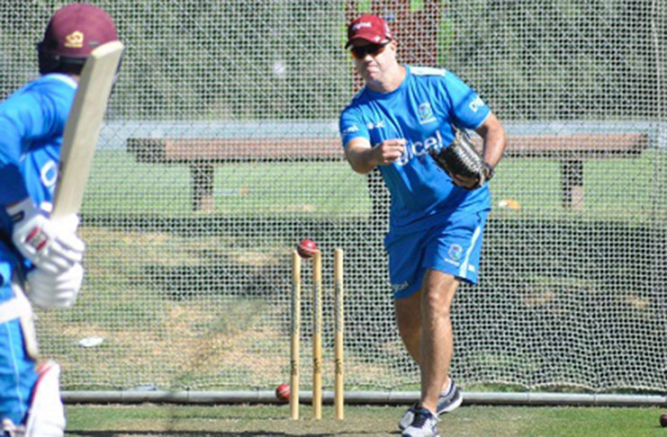 Head coach Stuart Law conducts throw-downs to batsman Shai Hope during a training session yesterday. (Photo courtesy CWI Media)