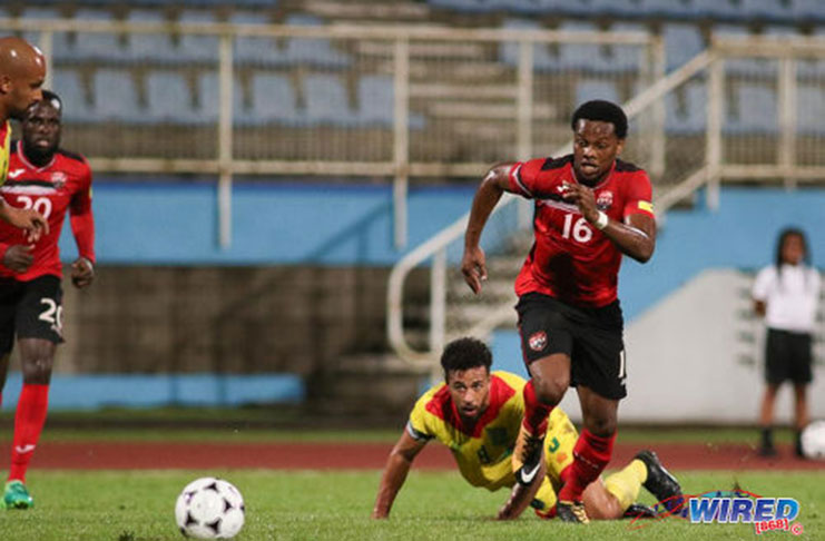 Trinidad and Tobago attacker Levi Garcia (right) leaves Guyana captain Samuel Cox for dead during international friendly action at the Ato Boldon Stadium in Couva on  November 14 2017. (Courtesy Chevaughn Christopher/Wired868)