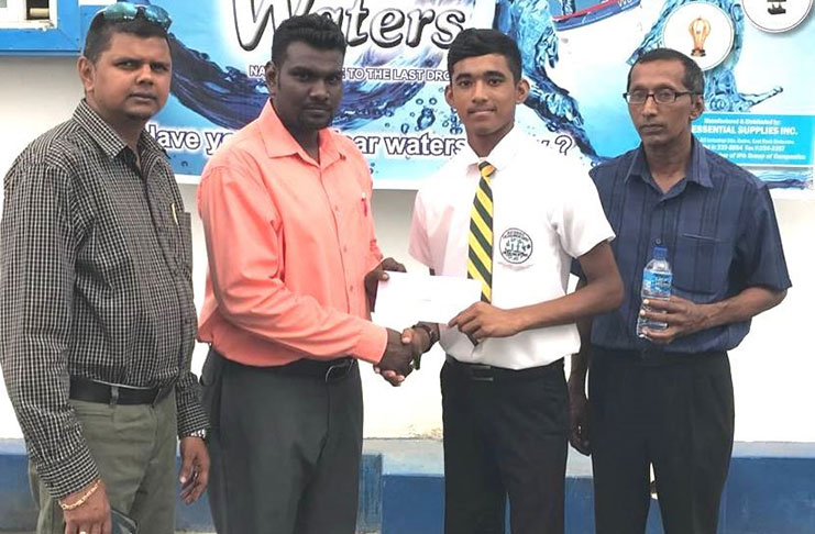 Mr Rickey Lucknauth (Clear Waters Operations Manager) and Mr Amarjeet Hardat (Clear Waters Marketing/Sales & Distribution Manager) hand over sponsorship cheque to Mr Yeudistir Persaud standing beside a proud father Mr Latchman Singh.