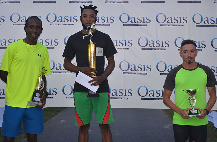 Winston Missigher, flanked by Cleveland Thomas (first from left) and Jonathan Fagundes on the medal podium after winning the AAG/Oasis Water 5km Run/Walk (Rawle Toney photo)