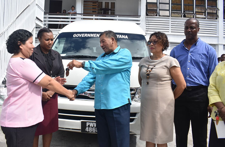 Minister of Indigenous Peoples’ Affairs, Sydney Allicock hands over the key to the minibus to Administrator of the facility, Claire Emmanuel, in the presence of  Minister within the Ministry Valerie Garrido-Lowe and other officials.