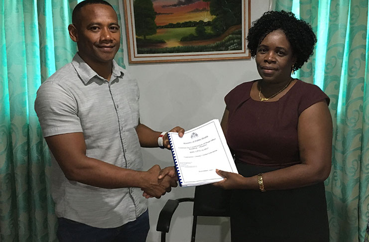 Permanent Secretary, Colette Adams hands over the contract to Cleon Chung, Chief Executive Officer (CEO) of Chung’s Global Enterprise.