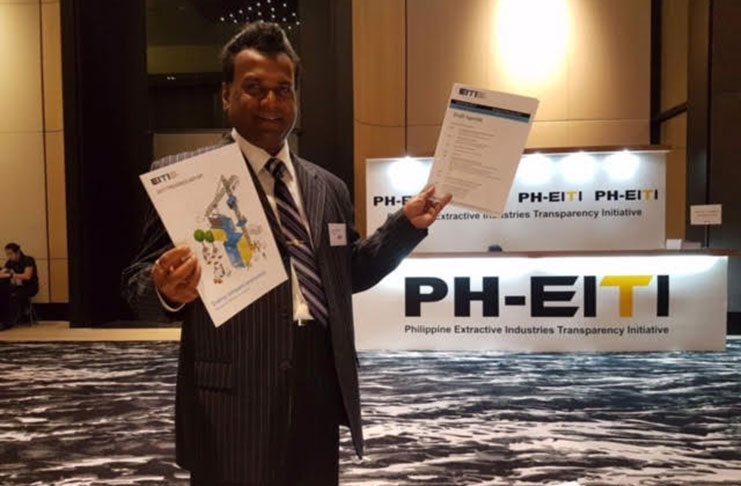Dr. Rudy Jadoopat displays the documents of the PH-EITI following Guyana's successful application for membership of the global group of Nations.