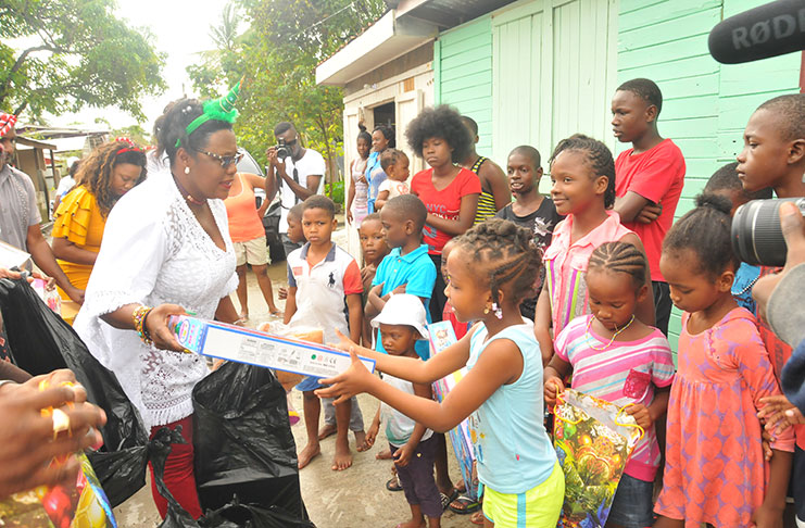Children of Rasville receiving their gifts from Minister Simona Broomes