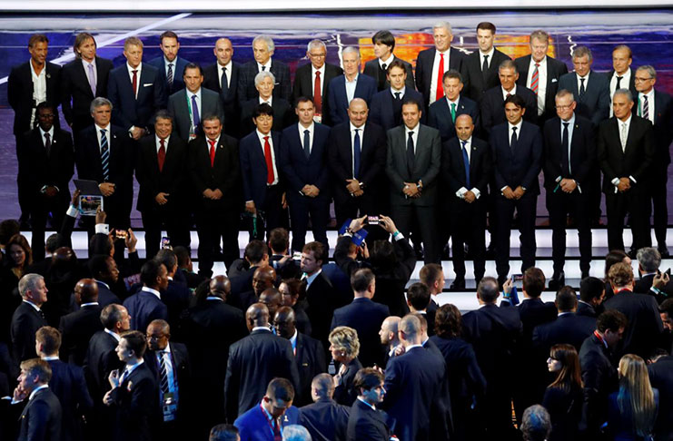 The nations coaches pose for a photo after the draw on Friday. (REUTERS/Kai Pfaffenbach)