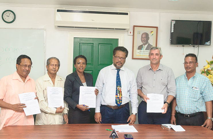 Representatives of the Department of Labour, Amazon Caribbean (Guyana) Limited and GAWU after the inking of the agreements on Friday