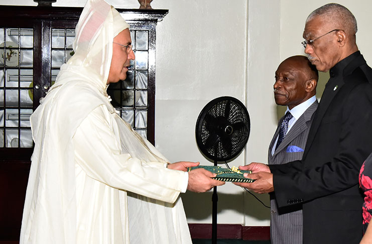 Moroccan Ambassador Nabil Adghoghi presenting his Letters of Credence to President David Granger on Wednesday in the presence of Foreign Affairs Minister Carl Greenidge (Ministry of the Presidency photo)