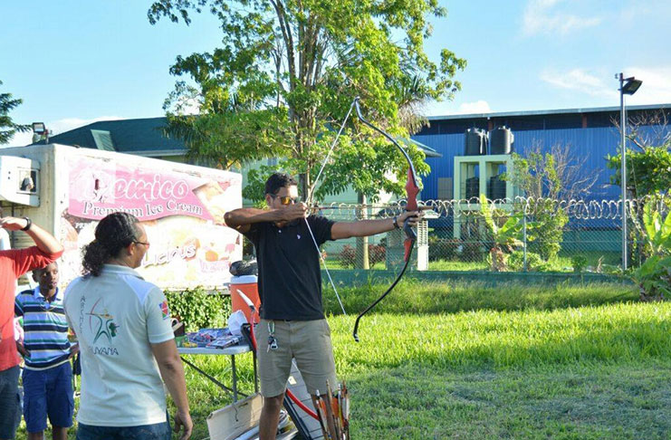 Jonathan DeGroot trying his hand at the bow for the first time. He was the winner of the grand prize.