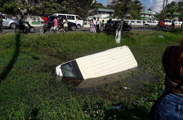 The partially submerged minibus in the Vlissengen Road canal